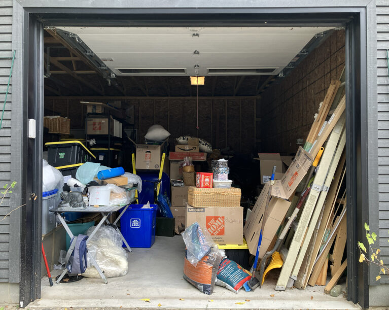 Open garage, full of unpacking-in-progress